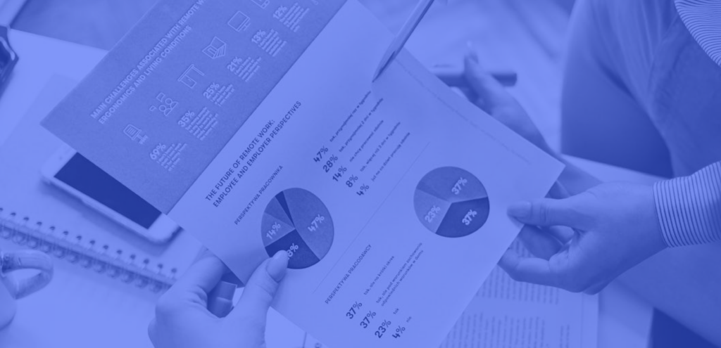 people looking down at and analyzing a market research report on a sheet of paper